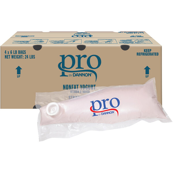 A package of Dannon Pro Nonfat Strawberry Parfait next to a box of Dannon Pro Nonfat Strawberry Parfait yogurt.