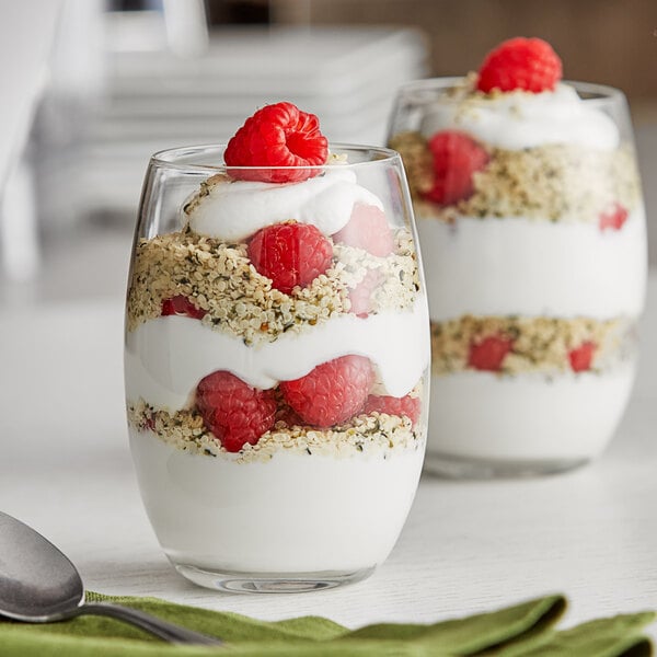 Two glasses of Oikos Pro Greek yogurt with raspberries and granola.