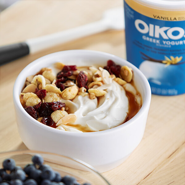 A bowl of Oikos nonfat Greek yogurt with nuts and blueberries.