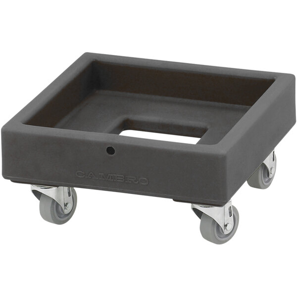 A charcoal grey plastic dolly with wheels on it for Cambro milk crates.