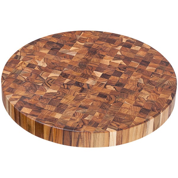 A Teakhaus round wooden cutting board with end grain.