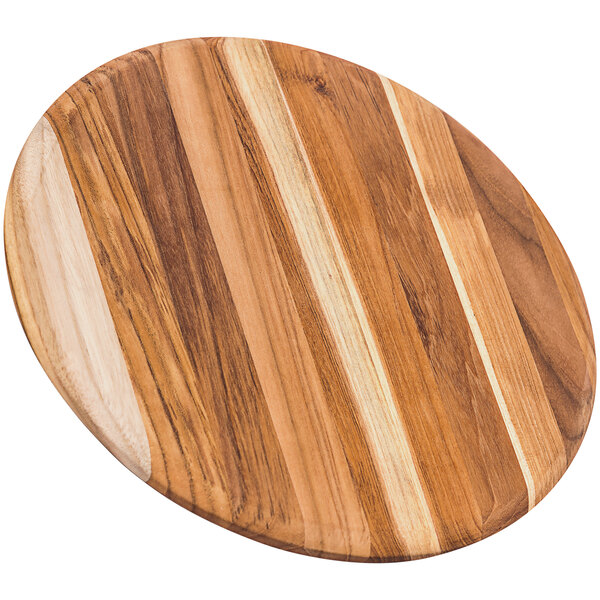 A Teakhaus teakwood round serving board with a striped design.