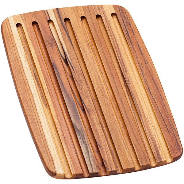 A Teakhaus teakwood bread board with vertical lines.
