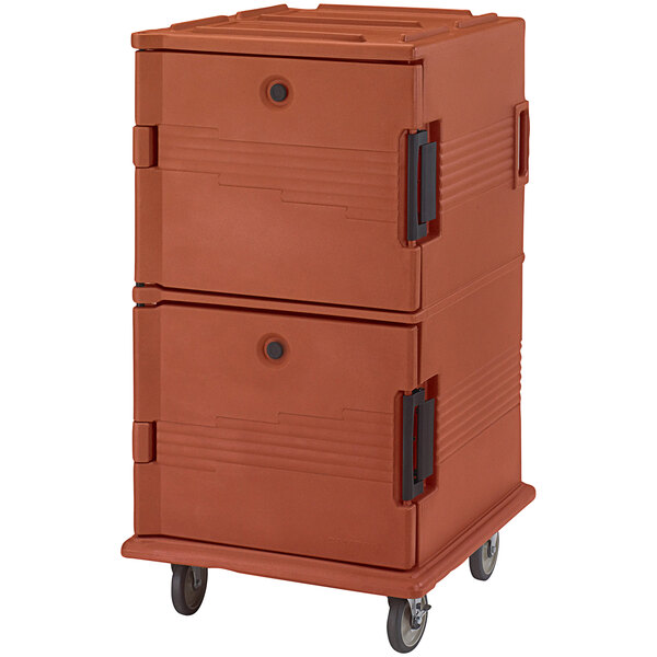 A brick red Cambro insulated food pan carrier with casters and black handles.