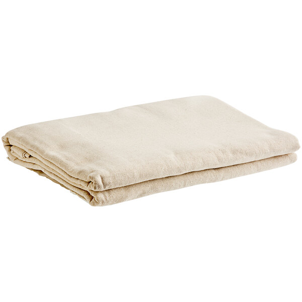 A stack of folded beige Monarch Brands canvas drop cloth runners.