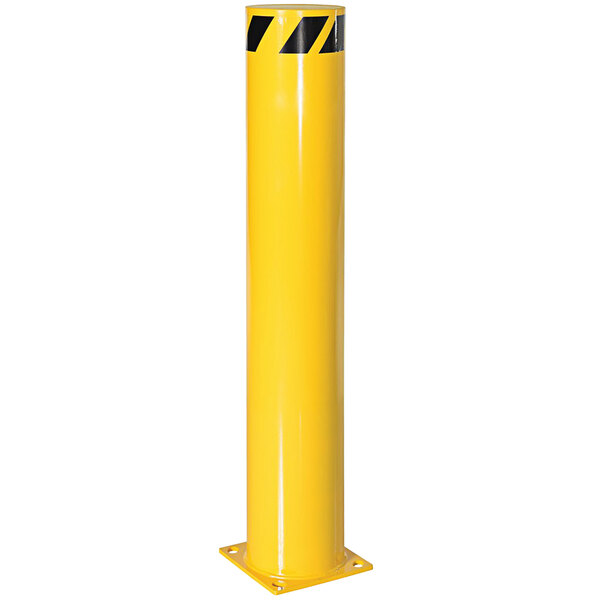 A yellow steel bollard with black stripes on top.