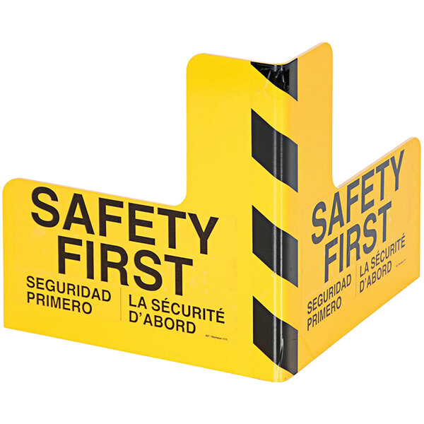 A yellow sign with black text reading "Safety First"