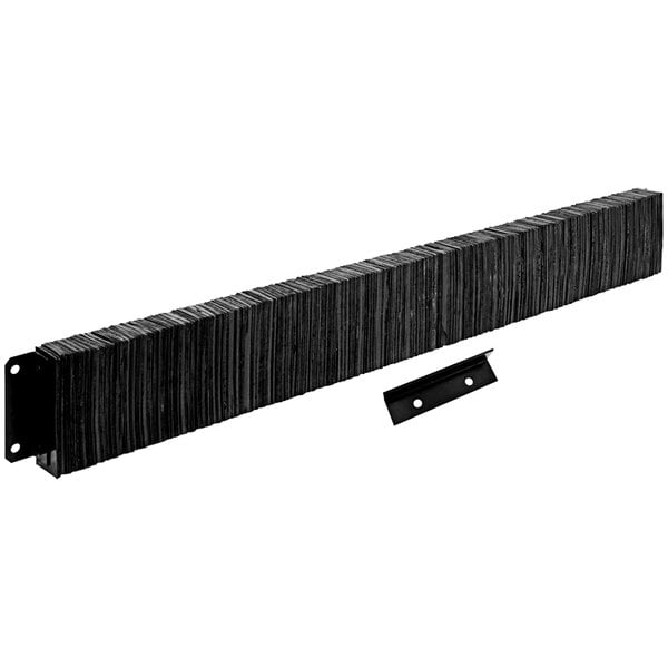 A stack of black rectangular rubber dock bumpers with metal bars.