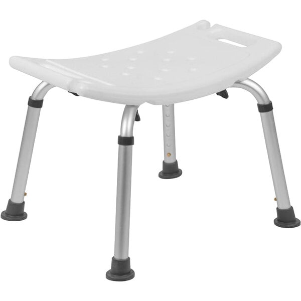 A white plastic Flash Furniture bath and shower chair with metal legs and holes in the seat.