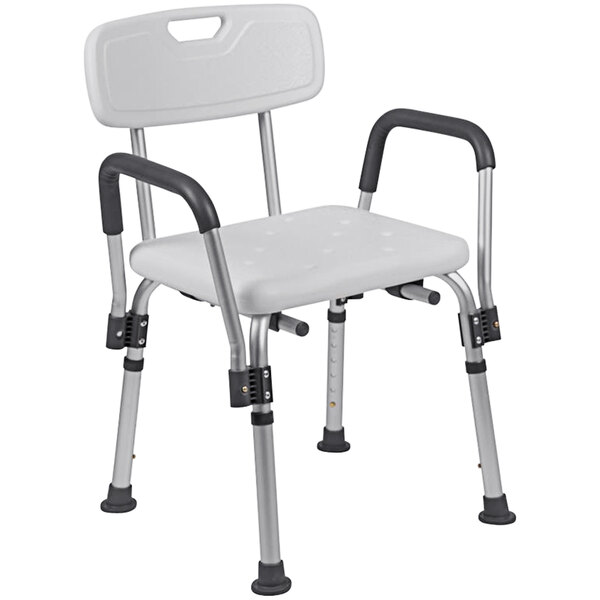 A white plastic Flash Furniture shower chair with metal legs and adjustable arms.