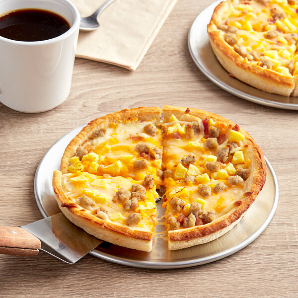 A Papa Primo's breakfast pizza with sausage and cheese on a plate.