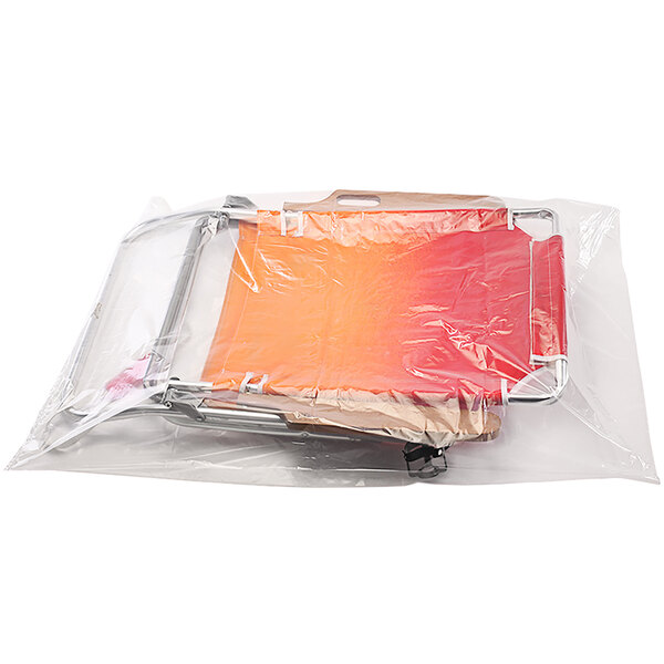 A Lavex clear plastic bag on a chair containing orange and red items.