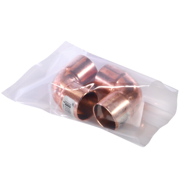 A clear plastic bag filled with copper pipes.