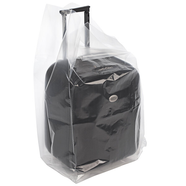 A Lavex clear plastic bag containing a black gusseted luggage bag.