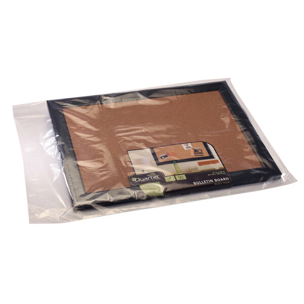 A Lavex clear flat poly bag holding a cork board.