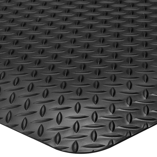 A close-up of a black Lavex Diamond Star rubber floor mat with a diamond pattern.