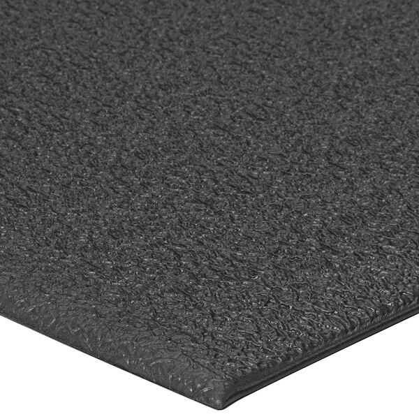 A close up of a black Lavex ArmorStep dual-density foam mat with a pebble emboss.