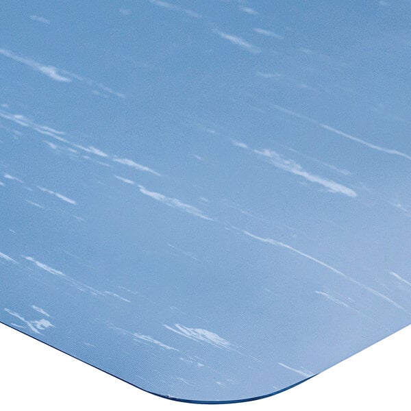 A blue anti-fatigue mat with a white marble pattern.