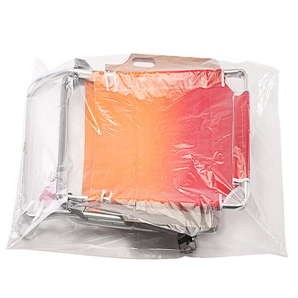 A clear Lavex poly bag with red and orange chairs inside.