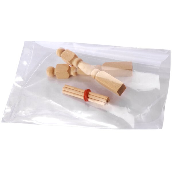 A clear plastic bag filled with wooden objects.