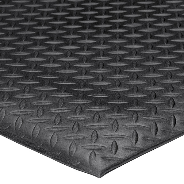 A close up of a black Lavex Diamond Deluxe anti-fatigue mat with a diamond pattern.