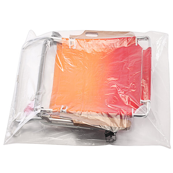 A white background with a clear plastic bag filled with red and yellow plastic bags.