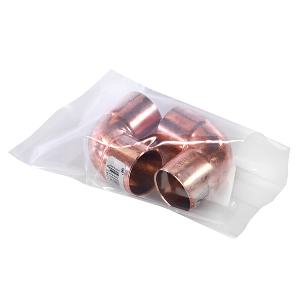 A clear plastic bag with two copper pipes inside.