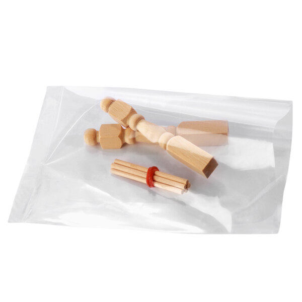 A bunch of wooden sticks on a clear Lavex poly bag.