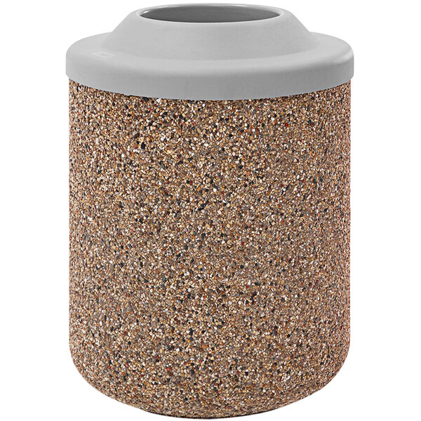 A close up of a stone cylinder with a gray and white Wausau Tile round trash can with a plastic lid inside.