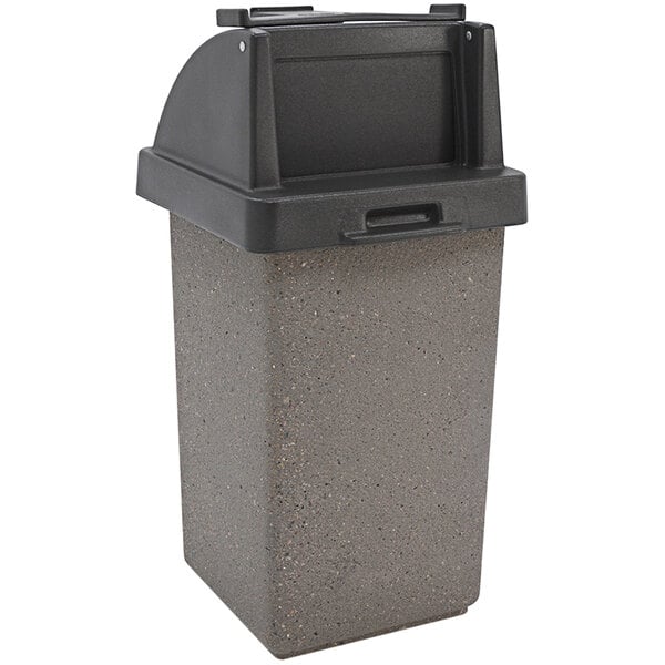 A grey rectangular Wausau Tile concrete trash can with a black lid.