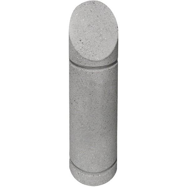 A close-up of a grey concrete cylinder with a beveled top.