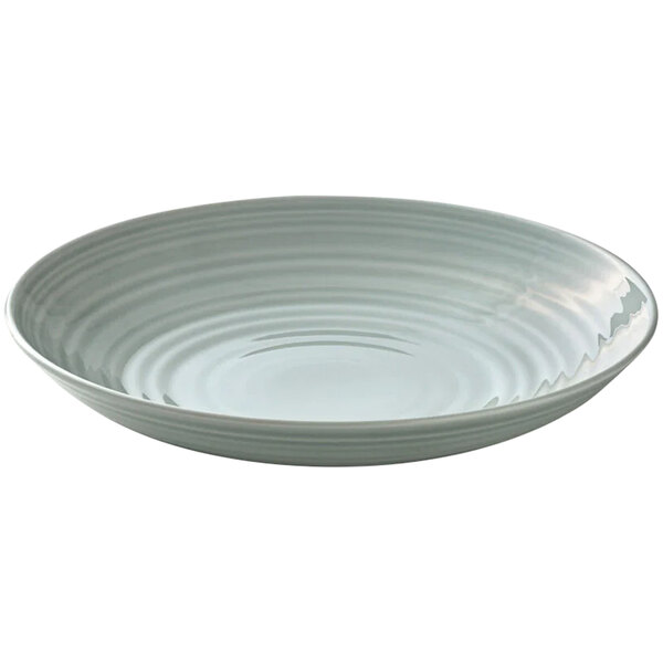 A white porcelain deep coupe plate with a wavy pattern.
