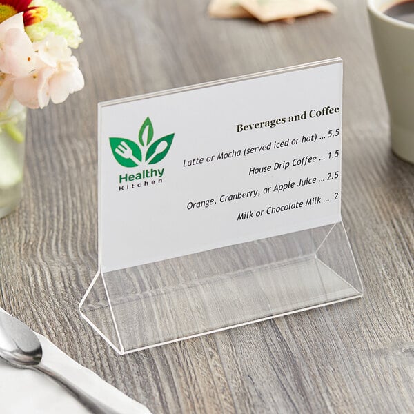 A clear acrylic Choice tabletop displayette with a menu on a table.