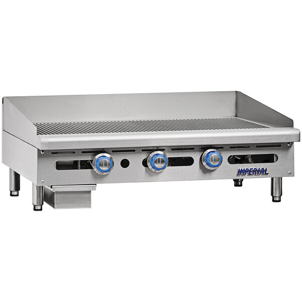 A large stainless steel Imperial Range liquid propane grooved griddle on a counter.