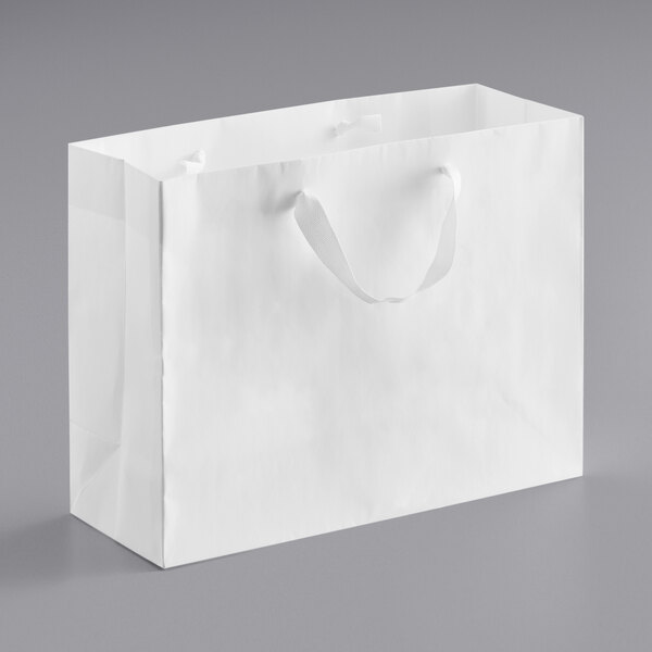 A customizable white paper bag with ribbon handles.