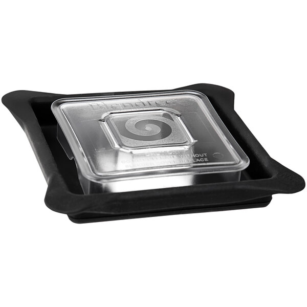 A clear plastic Blendtec container lid with a swirl design.