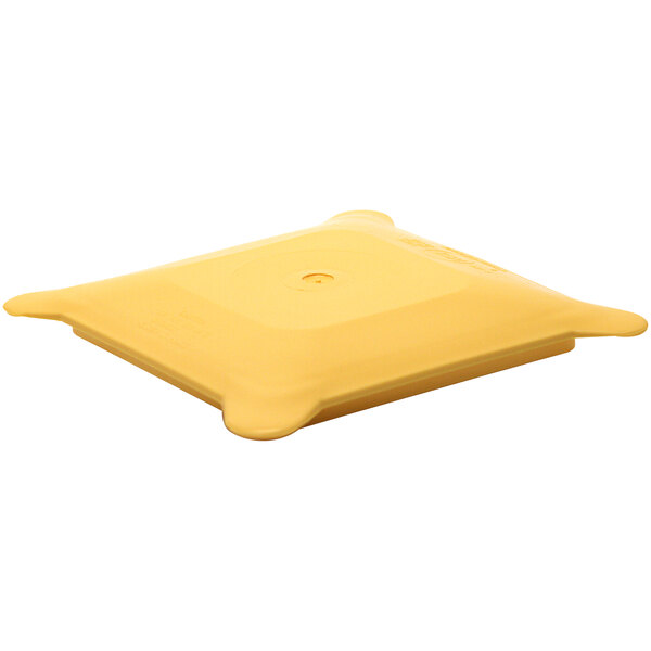 A yellow square plastic lid with a circle for a hole.