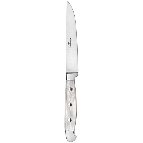A Chef & Sommelier stainless steel steak knife with a white handle.