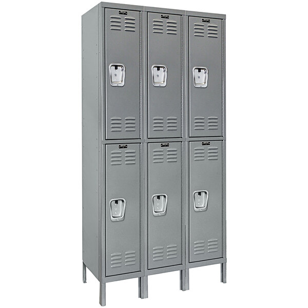 A row of grey Hallowell triple tier lockers with recessed handles.