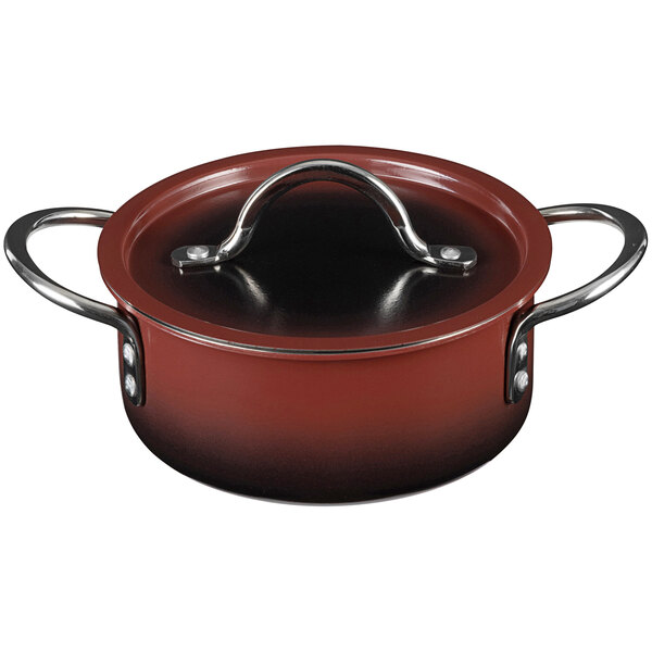 A red Bon Chef sauce pot with a metal handle and lid.