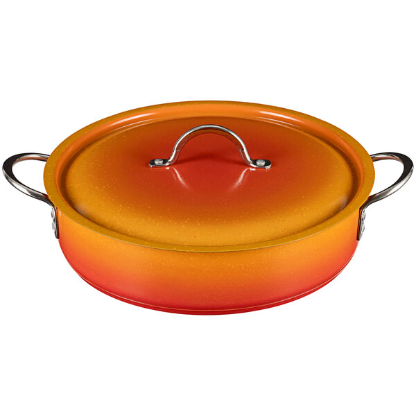 A Bon Chef Country French Ombre Tangerine Brazier pot with a silver lid handle.