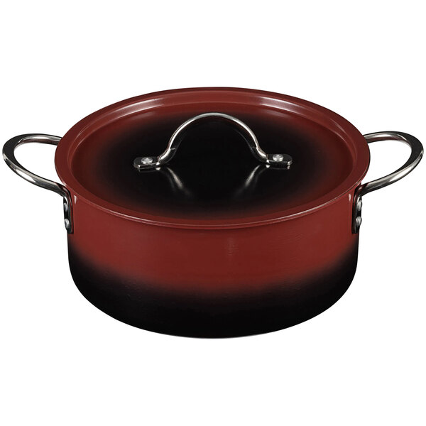 A red Bon Chef Country French sauce pot with a lid.