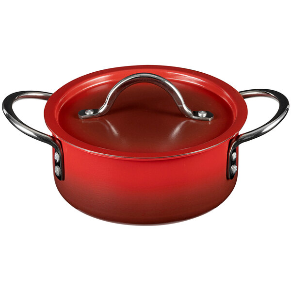 A Bon Chef Country French ombre crimson red sauce pot with a lid and metal handle.
