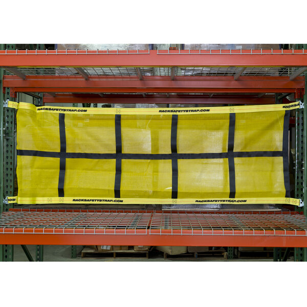 A yellow and black Adrian's Safety Solutions pallet rack safety net hanging on a rack.