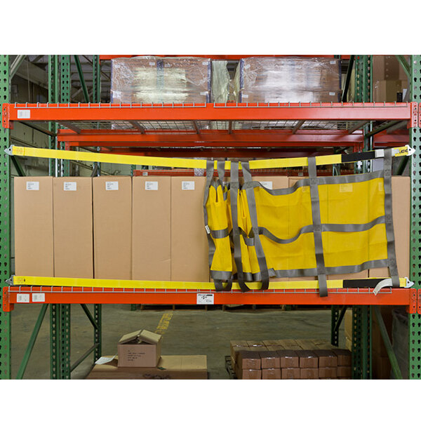 Adrian's Safety Solutions sliding pallet rack safety net with yellow vests on a shelf.