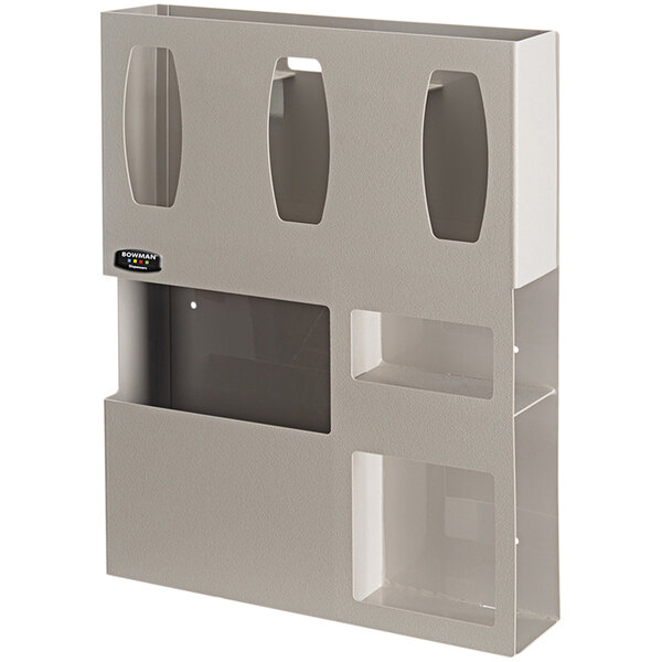 A white wall mounted BOWMAN dispenser with three compartments.