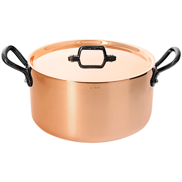 A de Buyer copper sauce pot with black handles and a lid.