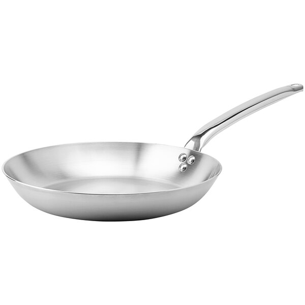 A close-up of a de Buyer stainless steel frying pan with a handle.
