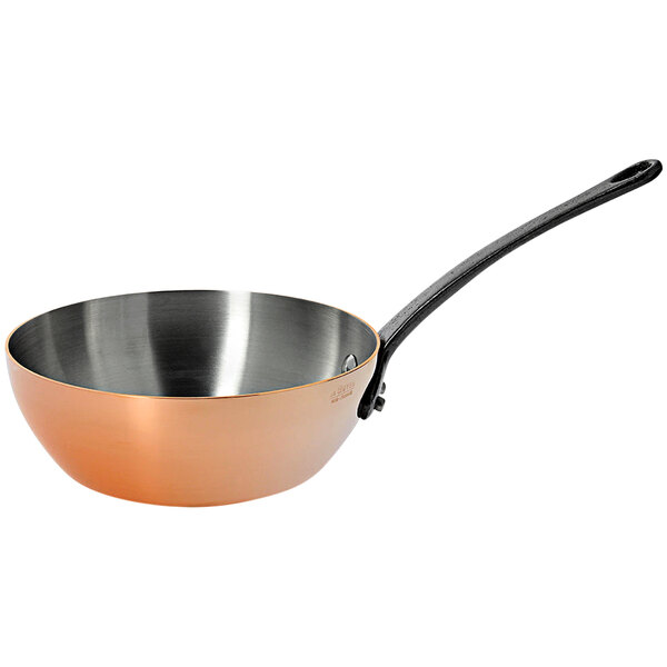 A de Buyer conical copper stir fry pan with a handle.