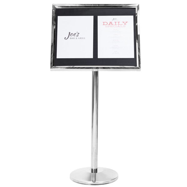 A black and white sign on a chrome pedestal stand.
